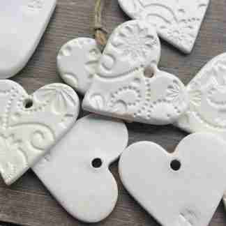 50 x Handmade Ceramic white heart ornament, with flower design, made with white clay
