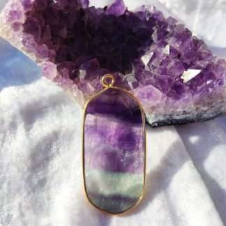 Framed fluorite crystal slice pendant.